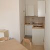 Cucina piccola con tavolo e sedie in legno.