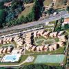 Complesso residenziale con case e campi sportivi visti dall'alto.