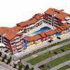 Complesso residenziale con tetti rossi, piscina interna e parcheggi.