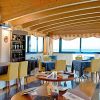 Sala con tavoli gialli sotto soffitto in legno.